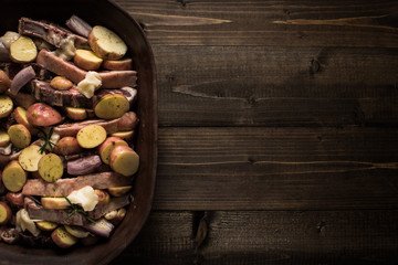 Lamb Loin Chops with Vegetables in Rustic Clay Dish Prepared for Roasting. Copy Space.