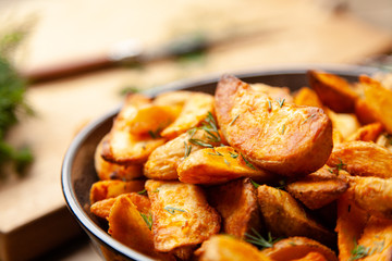 Baked potato fries on wooden table