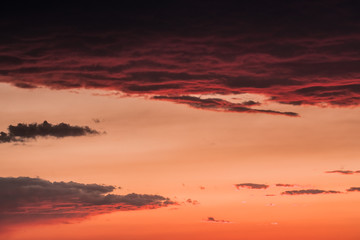 Fototapeta na wymiar Orange clouds on the sky at the sunset moment