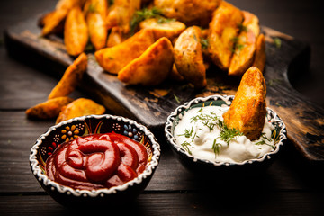 Baked potato fries on wooden table