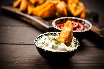 Baked potato fries on wooden table