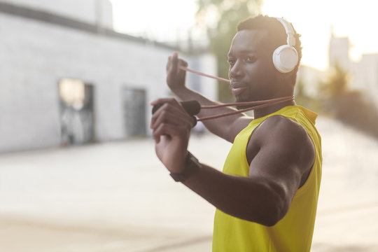 Portrait of handsome sporty afro man holding jump rope.