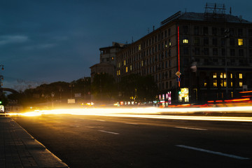 Road in the night city with light trails