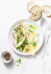 Greek yogurt, avocado, quinoa, breakfast bowl on white background, top view. Healthy diet food concept