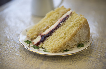 Large slice of raspberry jam sponge cake with cream 