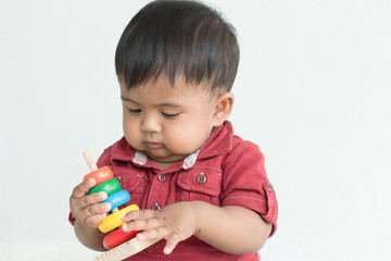 Cute asian little boy play wooden toys