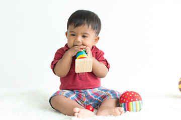 Cute asian little boy play wooden toys