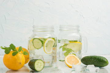 Rejuvenating drink, cocktail, tea, water with lemon, inbet, mint, cucumber in clear glass on a white background. Improvement and purification of the body. Detox.