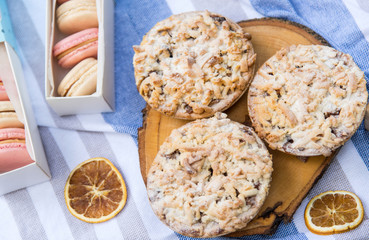 Colorful macaroons in a gift box. Sweet pies and cookies on a blue and white background. Top view. Happy holidays concept, picnic.