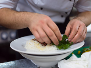 Chef hands serving spaghetti