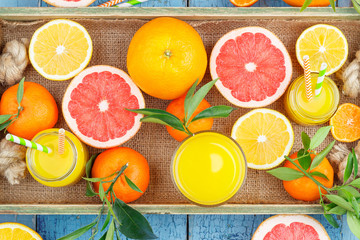 Different fruits and glass with fresh orange juice