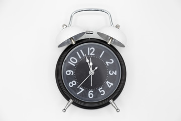 Closed up vintage analog clock isolated on white background.