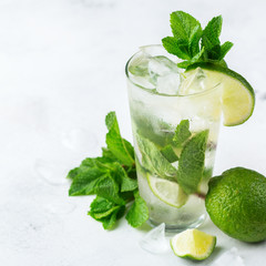Classic alcohol cocktail mojito with rum, soda, lime and mint