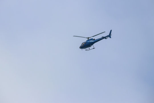Helicopter flying in blue sky