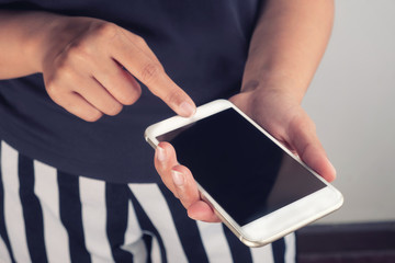 women and a smart phone in her hand in the room