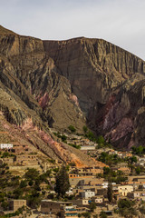 View of Iruya village and multicolored mountains in the surroundings at sunset, Salta province, Argentina, iruya - San Isidro - San Juan treeking