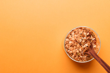Granola in a glass jar on a yellow background