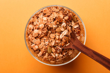 Granola in a glass jar on a yellow background