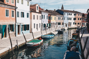 Fototapeta na wymiar View of Burano with traditional colorful houses and reflection in the water