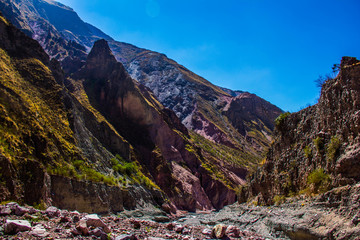 View of Iruya village and multicolored mountains in the surroundings at sunset, Salta province, Argentina, iruya - San Isidro - San Juan treeking