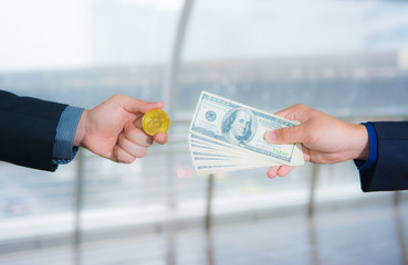 Two business men are exchanging between bitcoin and banknotes for financial concept between electronic and current currency