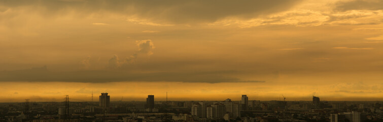 Blured cityscape of city during  sunset with golden light in the evening