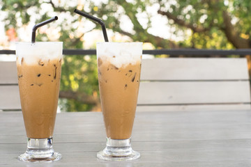 Cold coffee on wooden table for couple of love.