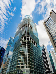 Fototapeta premium Ultra modern Capitagreen office tower with live tropical plants on each floor located near Raffles Place, Singapore. View of the downtown core of Singapore