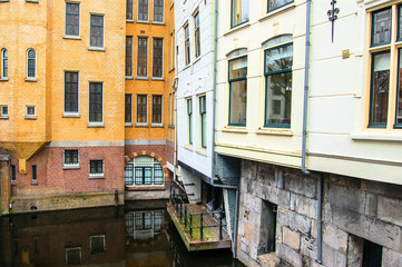 Fototapeta na wymiar Canal with colorful monumental buildings. Gouda, the Netherlands.