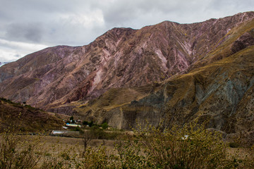 View of Iruya village and multicolored mountains in the surroundings at sunset, Salta province, Argentina, iruya - San Isidro - San Juan treeking