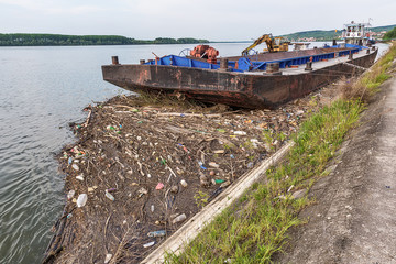 Naklejka premium Belgrade, Serbia April 24, 2018: Anchored ship on Ada Huja in Belgrade. A lot of trash near the ship.