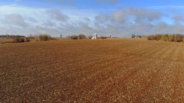 Fast moving cloud shadows create sublime beauty as they sweep across wet Springtime fields, drone hyperlapse.