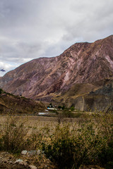 View of Iruya village and multicolored mountains in the surroundings at sunset, Salta province, Argentina, iruya - San Isidro - San Juan treeking