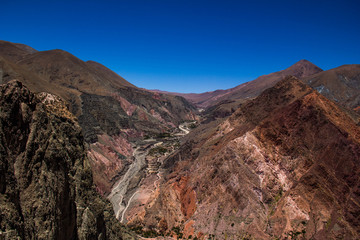 View of Iruya village and multicolored mountains in the surroundings at sunset, Salta province, Argentina, iruya - San Isidro - San Juan treeking