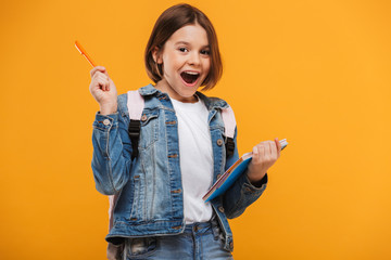 Portrait of an excited little schoolgirl with backpack
