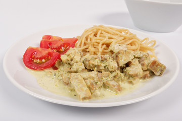 Spaghetti with tempeh and herb sauce on a white