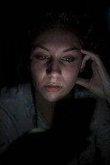 Young woman using mobile phone late at night