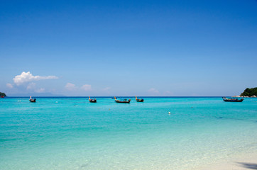Turquoise sea And blue sky White Sand Beach with taxi long tail boat, travel concept. Koh Lipe, Satun, Thailand