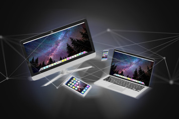 Devices like smartphone, tablet or computer flying over connection network - 3d render