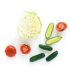 Fresh vegetables isolated on white background. Composition from a cut of cabbage, tomatoes and cucumbers, top view, flat lay. The concept of healthy food.