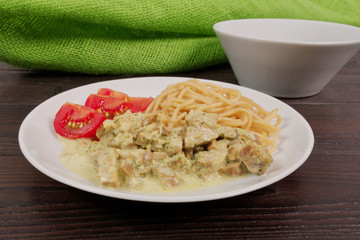 Spaghetti with tempeh and herb sauce on a table