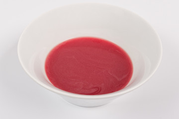 Beet soup with wine on a white