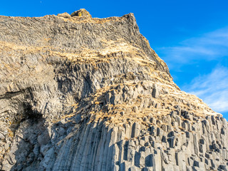 Basalt rock mountain near black sand beach in Iceland