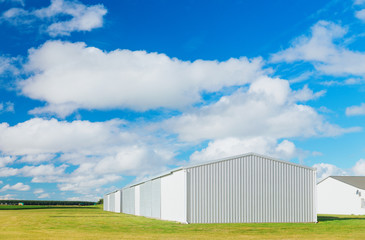 Fototapeta na wymiar Metallic warehouse with blue sky