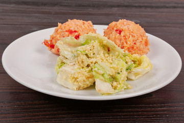 Tomato rice and salad on a table