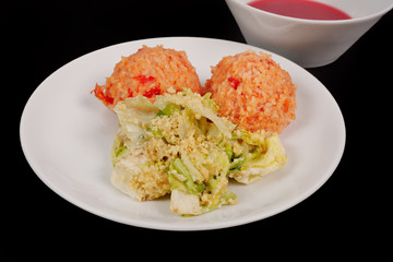 Tomato rice and salad on a black