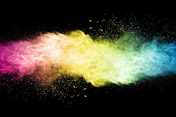 Explosion of multicolored dust on black background.
