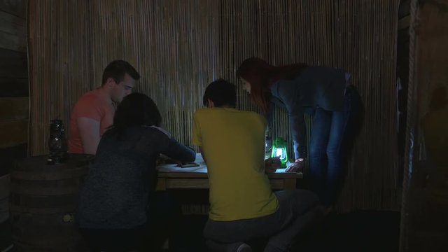 Players in an escape room game trying to solve a puzzle