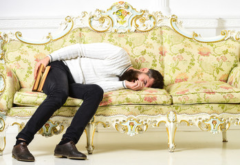 Macho sleep with book in hand. Boring literature concept. Man with beard and mustache lay on...