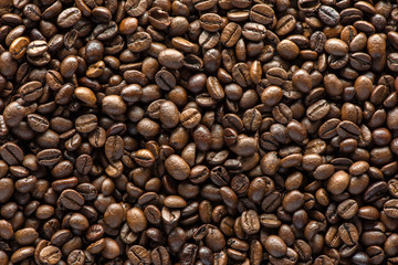 Roasted coffee beans on texture background.